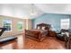 Spacious main bedroom with vaulted ceiling, ample natural light, and a calming blue accent wall at 5774 S Genoa Ct, Aurora, CO 80015