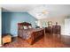 This luxurious main bedroom features a large bed, wood floors, and relaxing atmosphere at 5774 S Genoa Ct, Aurora, CO 80015