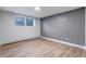 Bright bedroom with clean lines, laminate flooring, and natural light from a window at 3047 W 47Th Ave # 105, Denver, CO 80211