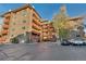 Brick apartment building featuring multiple balconies and parking spaces for residents and visitors at 3047 W 47Th Ave # 105, Denver, CO 80211
