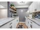 Modern kitchen with white cabinetry, sleek countertops, and stylish backsplash at 3047 W 47Th Ave # 105, Denver, CO 80211