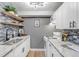 Updated kitchen with granite countertops, stainless steel sink, and stylish backsplash at 3047 W 47Th Ave # 105, Denver, CO 80211