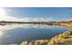 Scenic lake view with tranquil water, distant mountains, and clear blue sky at 3047 W 47Th Ave # 105, Denver, CO 80211