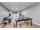 Cozy living room with comfortable seating, bright window, and dining area at 3047 W 47Th Ave # 105, Denver, CO 80211