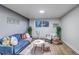 Cozy living room featuring a blue velvet sofa, stylish décor, and bright natural lighting at 3047 W 47Th Ave # 105, Denver, CO 80211