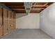 Unfinished basement space with exposed beams and concrete walls, offering potential for customization and added living space at 6611 Lamar St, Arvada, CO 80003