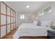 Cozy bedroom featuring a comfortable bed, natural light, and spacious closet at 6611 Lamar St, Arvada, CO 80003