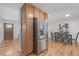 Dining room with stainless fridge, cabinets, and seating for six at 6611 Lamar St, Arvada, CO 80003