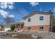 Inviting home showcasing a well-maintained lawn, charming front porch, a two-car garage, and mature trees at 6611 Lamar St, Arvada, CO 80003