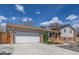 Home exterior with two-car garage, manicured landscaping, and welcoming walkway to the front entrance, showing curb appeal at 6611 Lamar St, Arvada, CO 80003