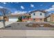 Charming home featuring a well-manicured front yard, gravel landscaping, and a two-car garage at 6611 Lamar St, Arvada, CO 80003