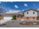 Charming home featuring a well-manicured front yard, gravel landscaping, and a two-car garage at 6611 Lamar St, Arvada, CO 80003