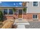 Close-up of the front entrance with well-kept landscaping and a charming front door, creating a welcoming first impression at 6611 Lamar St, Arvada, CO 80003