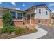 Charming home exterior with brick accents, updated siding, manicured landscaping, and a welcoming walkway to the front door at 6611 Lamar St, Arvada, CO 80003