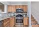 Updated kitchen with stainless steel appliances, gas range, and granite countertops at 6611 Lamar St, Arvada, CO 80003