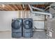 Efficient laundry area with modern washer and dryer units, alongside essential mechanical equipment, providing convenience and functionality at 6611 Lamar St, Arvada, CO 80003