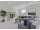 Comfortable living room with a gray sofa, fireplace, and large windows for natural light at 6611 Lamar St, Arvada, CO 80003
