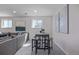 Living room featuring a dining table and a cozy seating area, with natural light coming through windows at 6611 Lamar St, Arvada, CO 80003