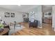 Inviting living area with modern decor, hardwood floors, and seamless flow to the dining area and kitchen for easy living at 6611 Lamar St, Arvada, CO 80003
