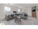 Cozy living room featuring a large gray sectional sofa and stylish decor, perfect for relaxing or entertaining guests at 6611 Lamar St, Arvada, CO 80003