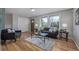 Bright living room with hardwood floors, large windows, modern decor, and comfortable seating for Gathering gatherings and relaxation at 6611 Lamar St, Arvada, CO 80003