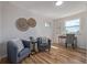 Stylish living room features hardwood floors, natural light, and views of backyard at 6611 Lamar St, Arvada, CO 80003