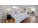 Serene bedroom with hardwood floors, neutral decor, ample natural light, and a cozy seating area for relaxation at 6611 Lamar St, Arvada, CO 80003