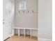 Mudroom featuring a bench with storage and coat hooks on the white wall at 2150 Eliot St, Denver, CO 80211