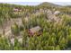 Breathtaking aerial view of a beautiful log home nestled in a lush forest, providing privacy and scenic beauty at 1673 Sinton Rd, Evergreen, CO 80439