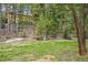 Backyard of cabin among mature trees at 1673 Sinton Rd, Evergreen, CO 80439