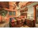This bedroom has wood paneled walls, exposed beams, and a decorative ceiling fan with an overhead light at 1673 Sinton Rd, Evergreen, CO 80439