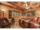 Cozy bedroom featuring warm wood finishes, a comfortable bed, and scenic views from the windows, creating a relaxing retreat at 1673 Sinton Rd, Evergreen, CO 80439
