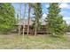 Charming log home with a welcoming covered porch, set amidst a serene forest landscape, and ample firewood at 1673 Sinton Rd, Evergreen, CO 80439