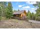 Charming log home with a large deck overlooking the surrounding forest, perfect for enjoying the outdoors at 1673 Sinton Rd, Evergreen, CO 80439