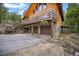 Two-car garage with a spacious driveway and stone accents on the exterior at 1673 Sinton Rd, Evergreen, CO 80439