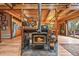 Cozy open-concept living space featuring wood beams, a fireplace, and seamless flow to the kitchen and dining area at 1673 Sinton Rd, Evergreen, CO 80439