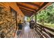 Relaxing porch with wood flooring, grill, rocking chairs and welcome sign at 1673 Sinton Rd, Evergreen, CO 80439