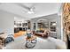 Bright living room with a stone fireplace and views of the kitchen and backyard at 1696 Waneka Lake Trl, Lafayette, CO 80026