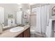 Bright bathroom features a shower-tub combination, a neutral countertop, and fresh white tiling at 1038 Mircos St, Erie, CO 80516