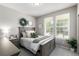Cozy bedroom featuring a decorative wreath, ample natural light, and neutral tones, creating a serene ambiance at 1038 Mircos St, Erie, CO 80516