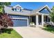 Charming blue two-story home with landscaped yard, solar panels, and covered porch with seating at 1038 Mircos St, Erie, CO 80516