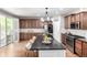 Lovely kitchen with stainless appliances, tile backsplash, and large island with seating at 1038 Mircos St, Erie, CO 80516