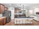 Spacious kitchen featuring a breakfast bar, stainless steel appliances, and modern finishes at 1038 Mircos St, Erie, CO 80516