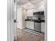 Convenient kitchenette with sleek white cabinets, stainless steel appliances, and modern finishes at 1038 Mircos St, Erie, CO 80516