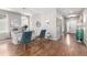 Charming living area with hardwood floors, stylish chairs, and a view to the entryway of the home at 1038 Mircos St, Erie, CO 80516
