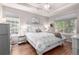 Bright bedroom with tray ceiling, hardwood floors, and large windows for lots of light at 1038 Mircos St, Erie, CO 80516