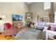 Inviting living room featuring a stone fireplace, vaulted ceilings, and comfortable seating, perfect for relaxation at 26345 Sweetbriar Trl, Evergreen, CO 80439