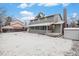 Back exterior view of the house with a covered patio and large backyard space at 1665 S Victor St, Aurora, CO 80012