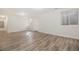 Finished basement boasts a new laminate floor, natural light, and fresh white paint at 1145 Rosemary St # 105, Denver, CO 80220