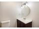 Cozy half bathroom with modern vanity, updated light fixture, and neutral paint at 1145 Rosemary St # 105, Denver, CO 80220